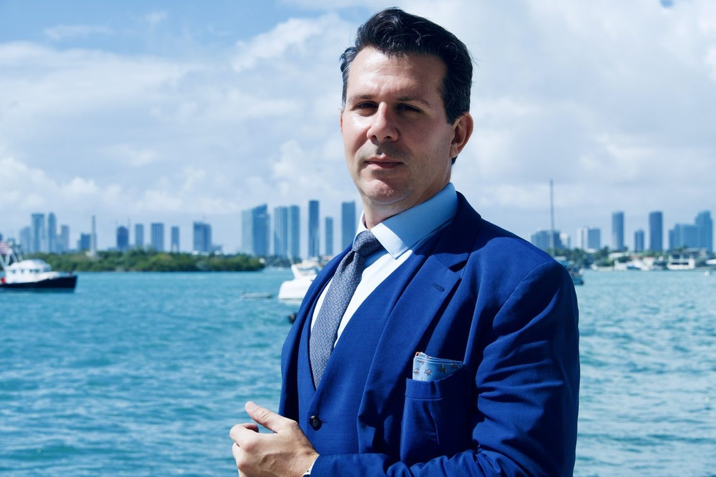 James Koutoulas on Biscayne Bay with the Miami skyline behind